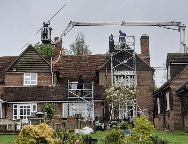 The Roof Moss Cleaners using cherry picker and scaffolding to clean roof safely and professionally in Blackfield, Hampshire